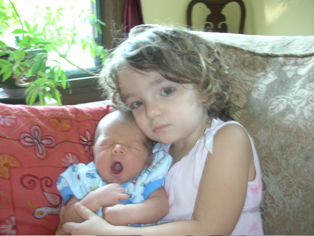 The big sister with a sleepy baby!
