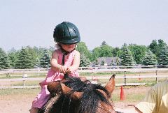 A budding equestrian - but we think she needs a smaller helmet!